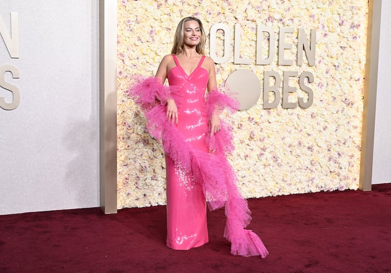 Margot Robbie at the 81st Golden Globe Awards wearing Armani.